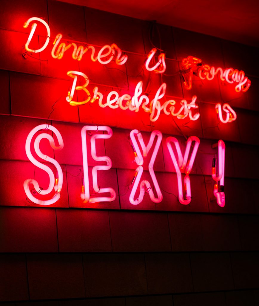 a neon sign that says dinner is fancy, breakfast is sexy